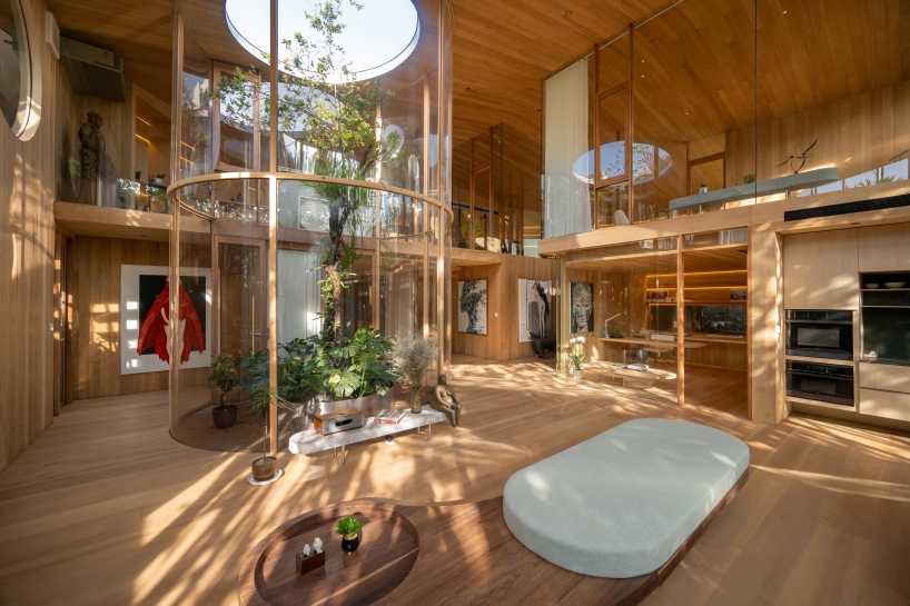 curved glass atriums penetrate residence&rsquo;s aluminum roof in bangkok