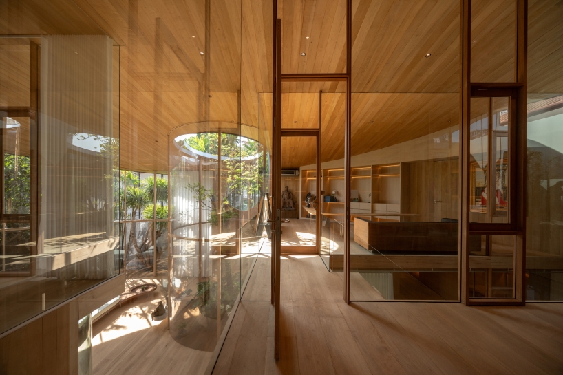 curved glass atriums penetrate residence&rsquo;s aluminum roof in bangkok