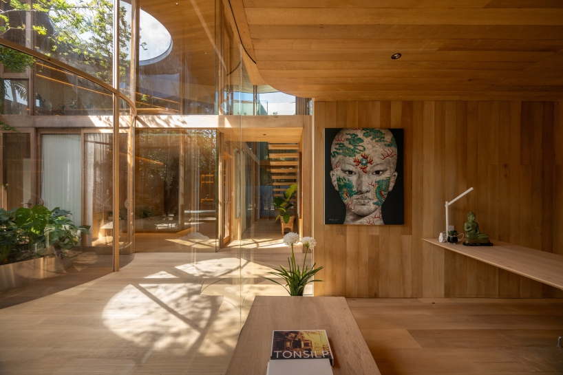 curved glass atriums penetrate residence&rsquo;s aluminum roof in bangkok