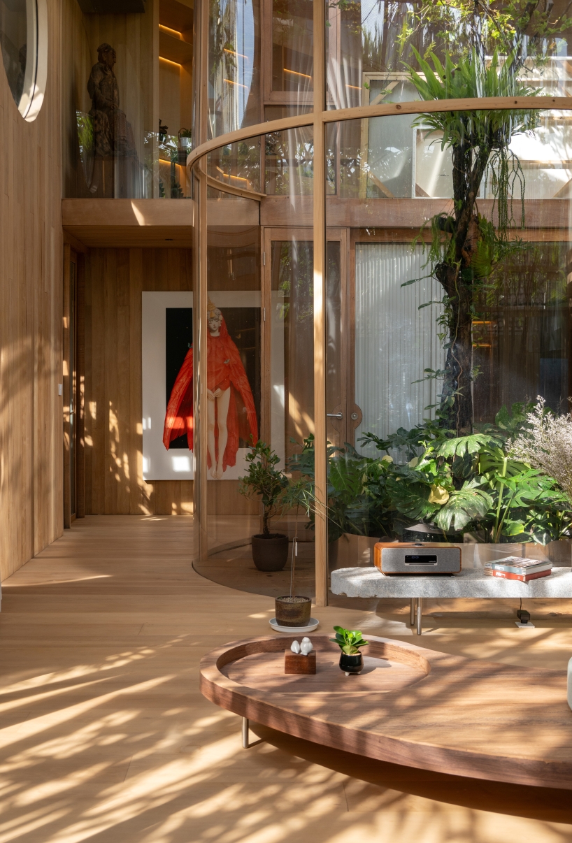 curved glass atriums penetrate residence&rsquo;s aluminum roof in bangkok