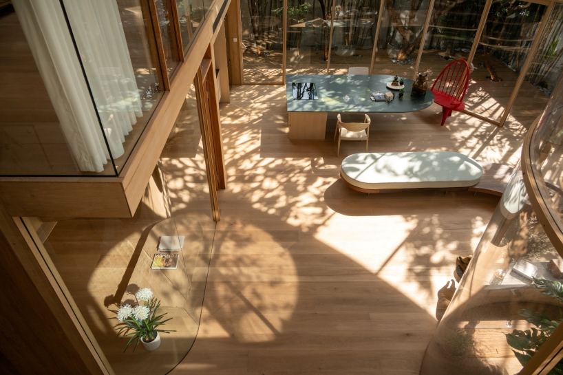 curved glass atriums penetrate residence&rsquo;s aluminum roof in bangkok