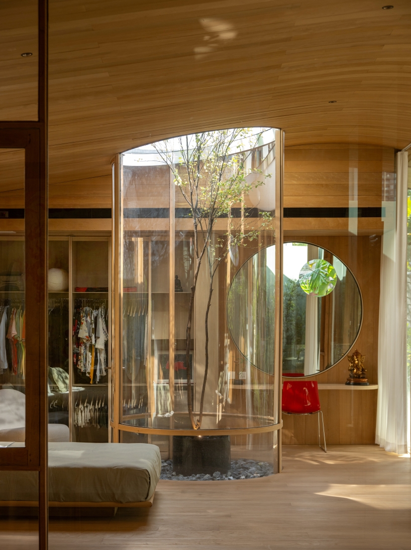 curved glass atriums penetrate residence&rsquo;s aluminum roof in bangkok