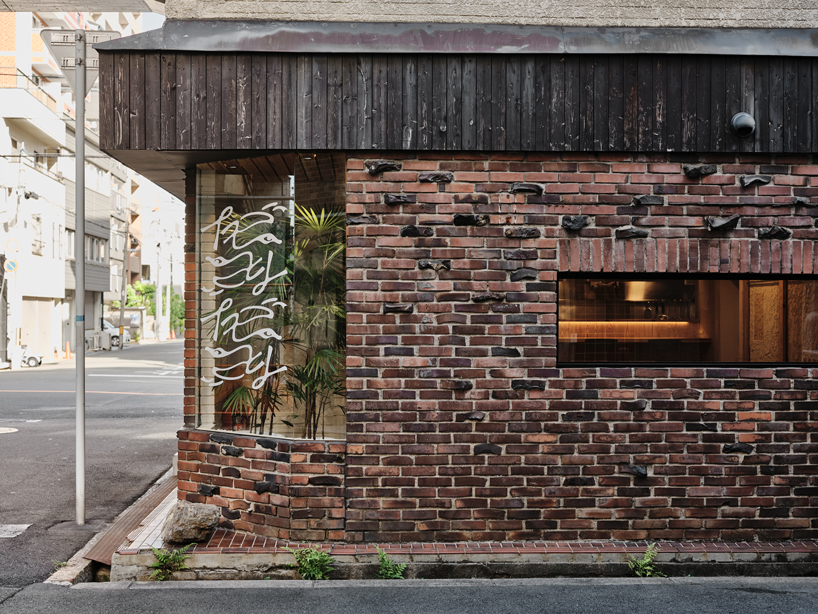 renovated restaurant by stod preserves its historic brick frame in japan
