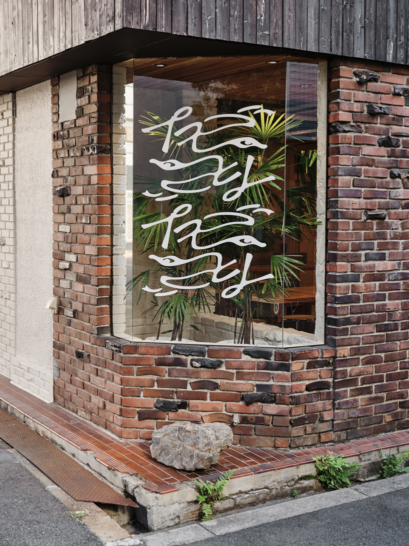 renovated restaurant by stod preserves its historic brick frame in japan