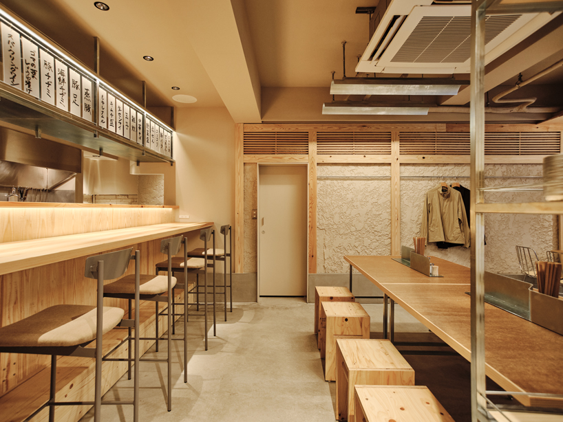 renovated restaurant by stod preserves its historic brick frame in japan