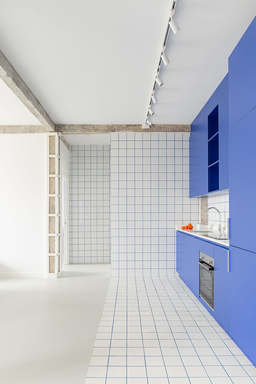 blue and white interiors link renovated 1930s apartment to its seaside setting in spain