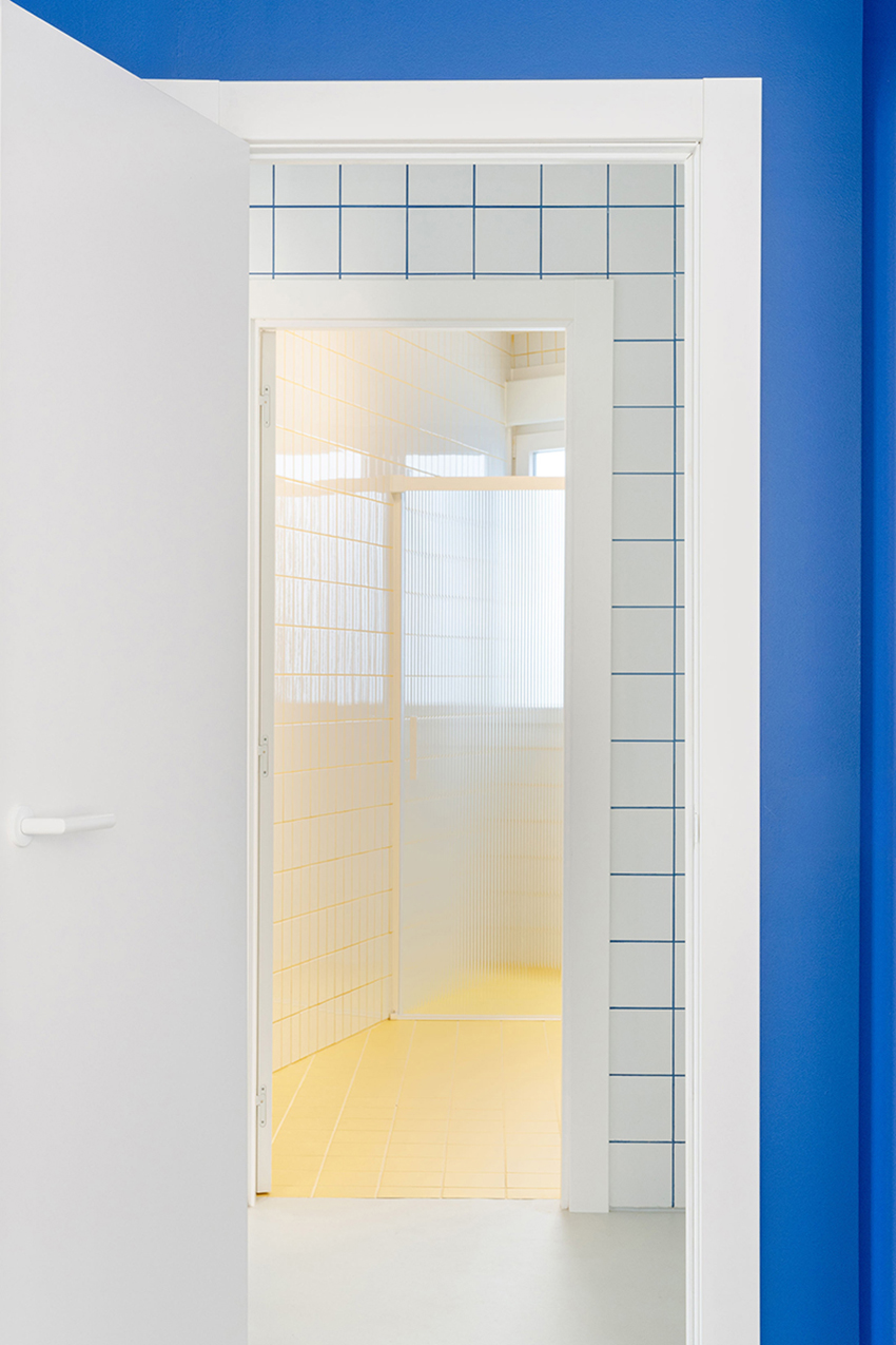 blue and white interiors link renovated 1930s apartment to its seaside setting in spain