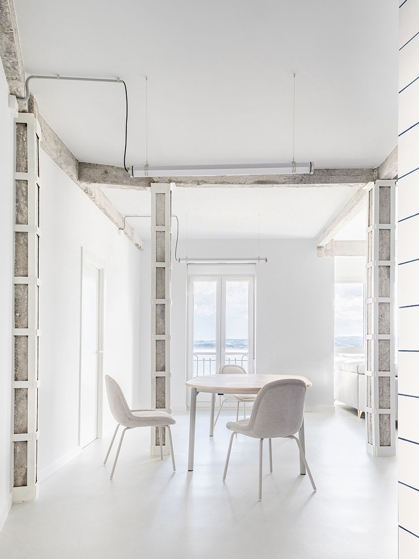 blue and white interiors link renovated 1930s apartment to its seaside setting in spain