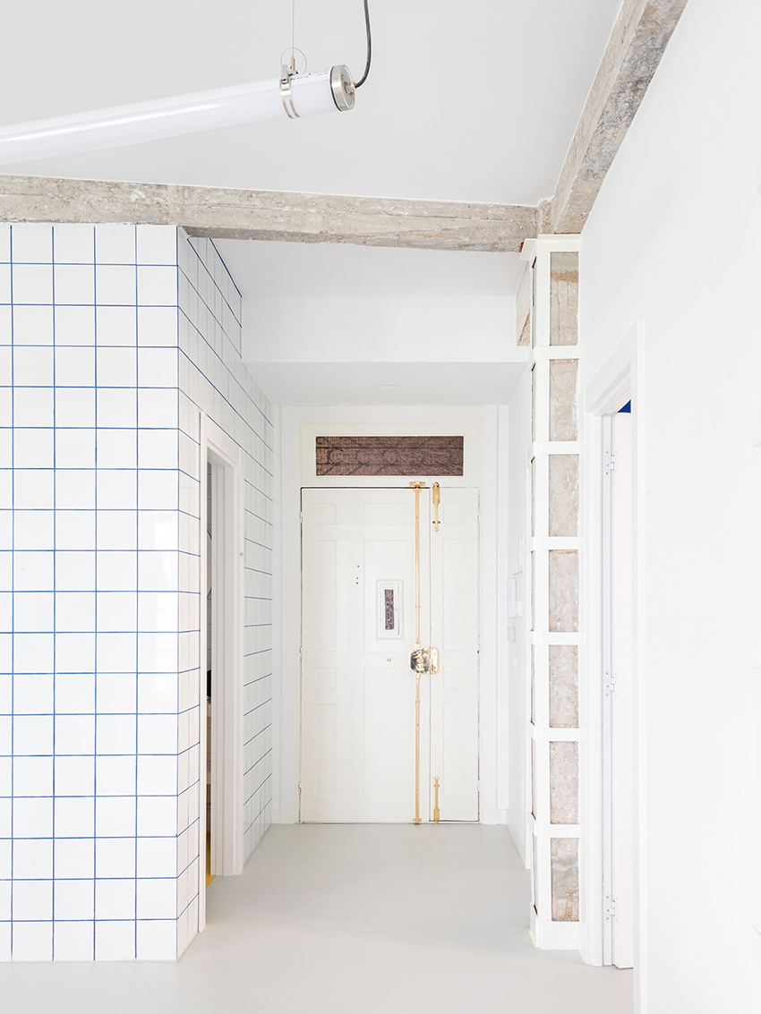 blue and white interiors link renovated 1930s apartment to its seaside setting in spain