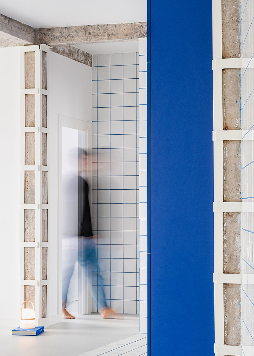 blue and white interiors link renovated 1930s apartment to its seaside setting in spain