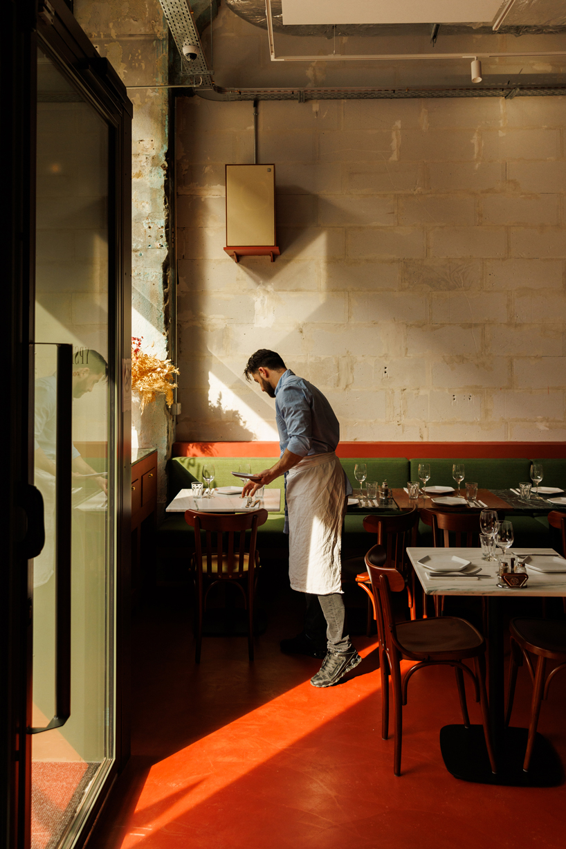 red floor anchors parisian restaurant ypseli with steel and marble textures - 8