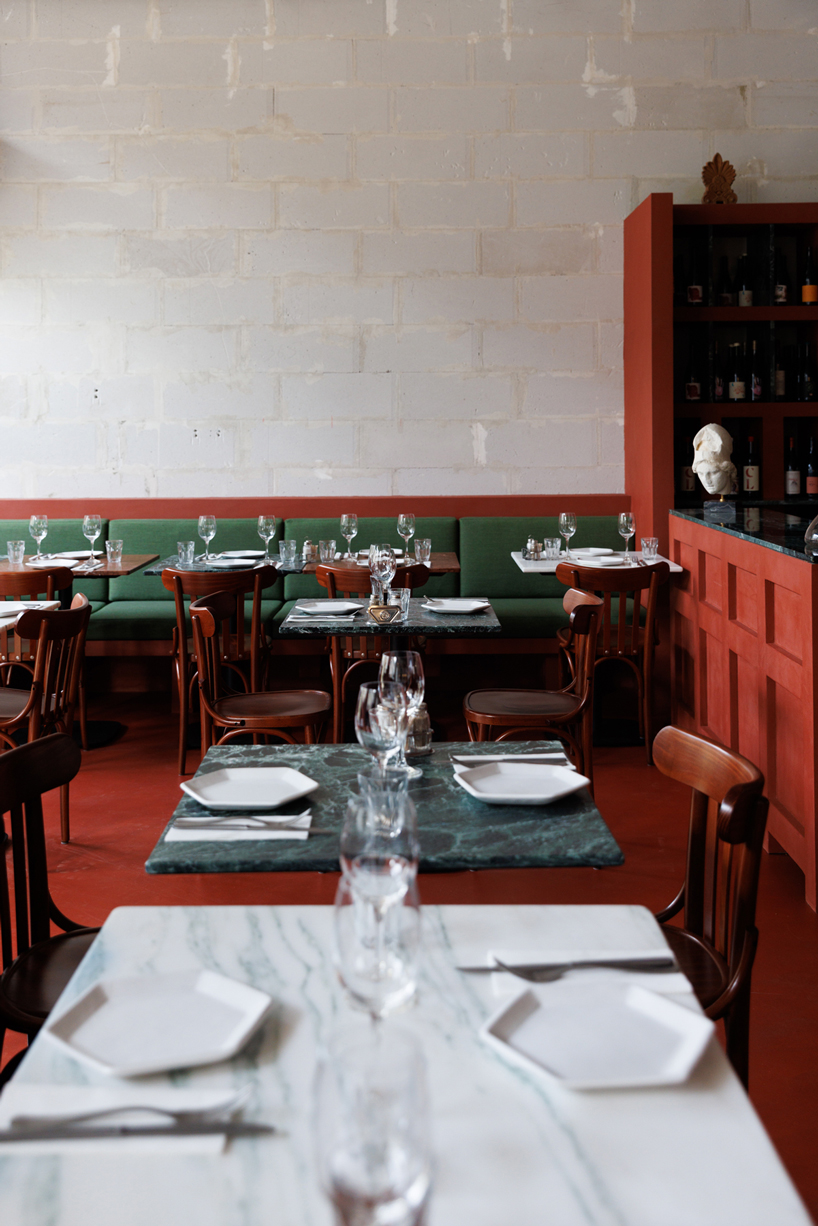 red floor anchors parisian restaurant ypseli with steel and marble textures - 9
