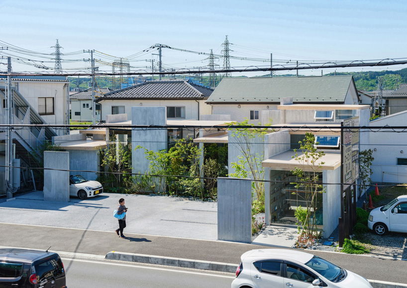 layers of wooden, concrete and mirrored surfaces combine to compose hair salon in japan