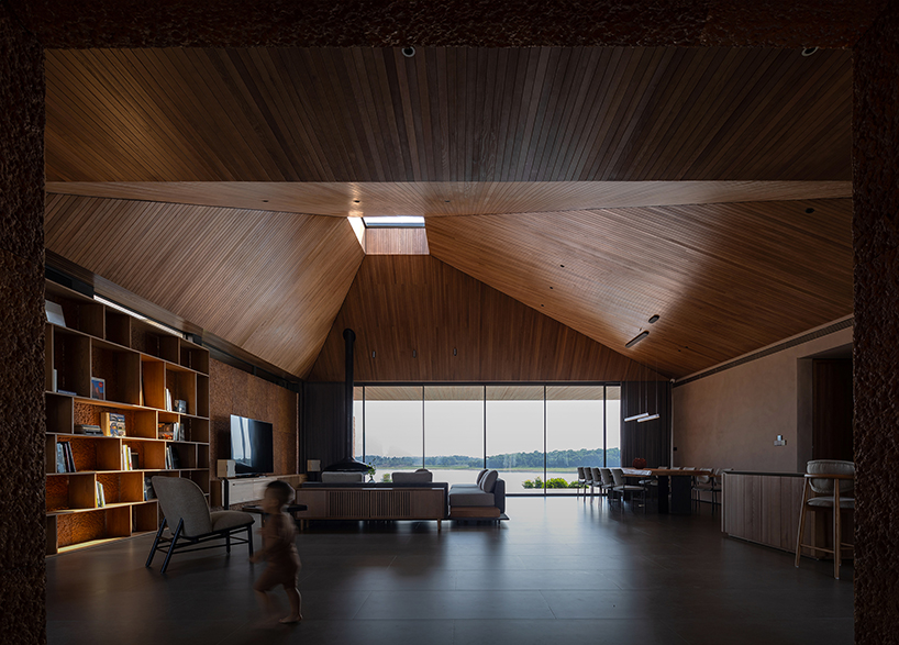 wooden pyramid skylight illuminates suoi hai villa's interior in vietnam