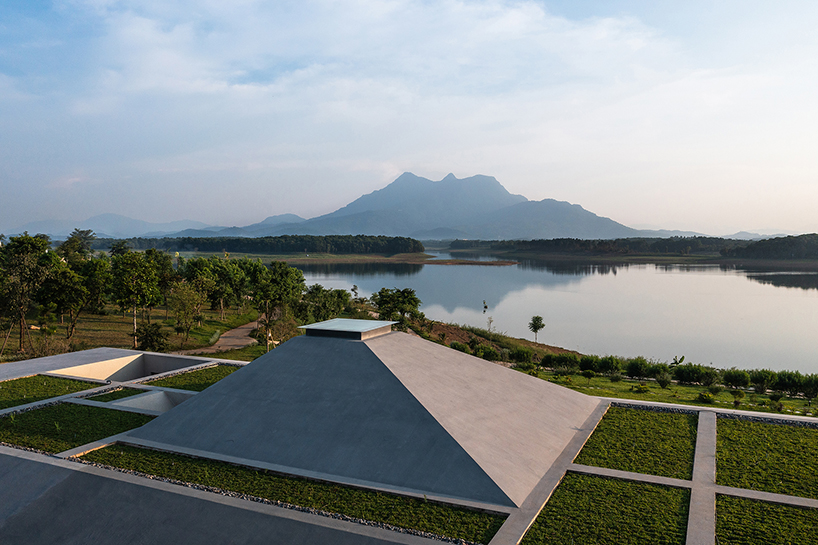 wooden pyramid skylight illuminates suoi hai villa's interior in vietnam