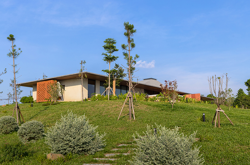 wooden pyramid skylight illuminates suoi hai villa's interior in vietnam