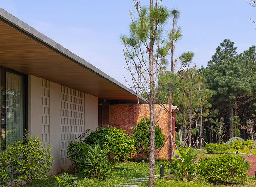 wooden pyramid skylight illuminates suoi hai villa's interior in vietnam