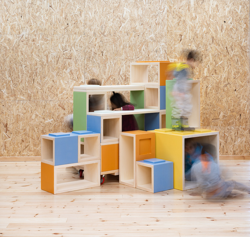 modular furniture pieces assemble to form varying play scenarios within lisbon-based school