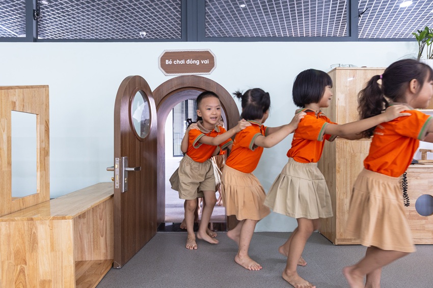 elliptical classroom volumes and colorful louvers shape courtyard kindergarten in hanoi - 7