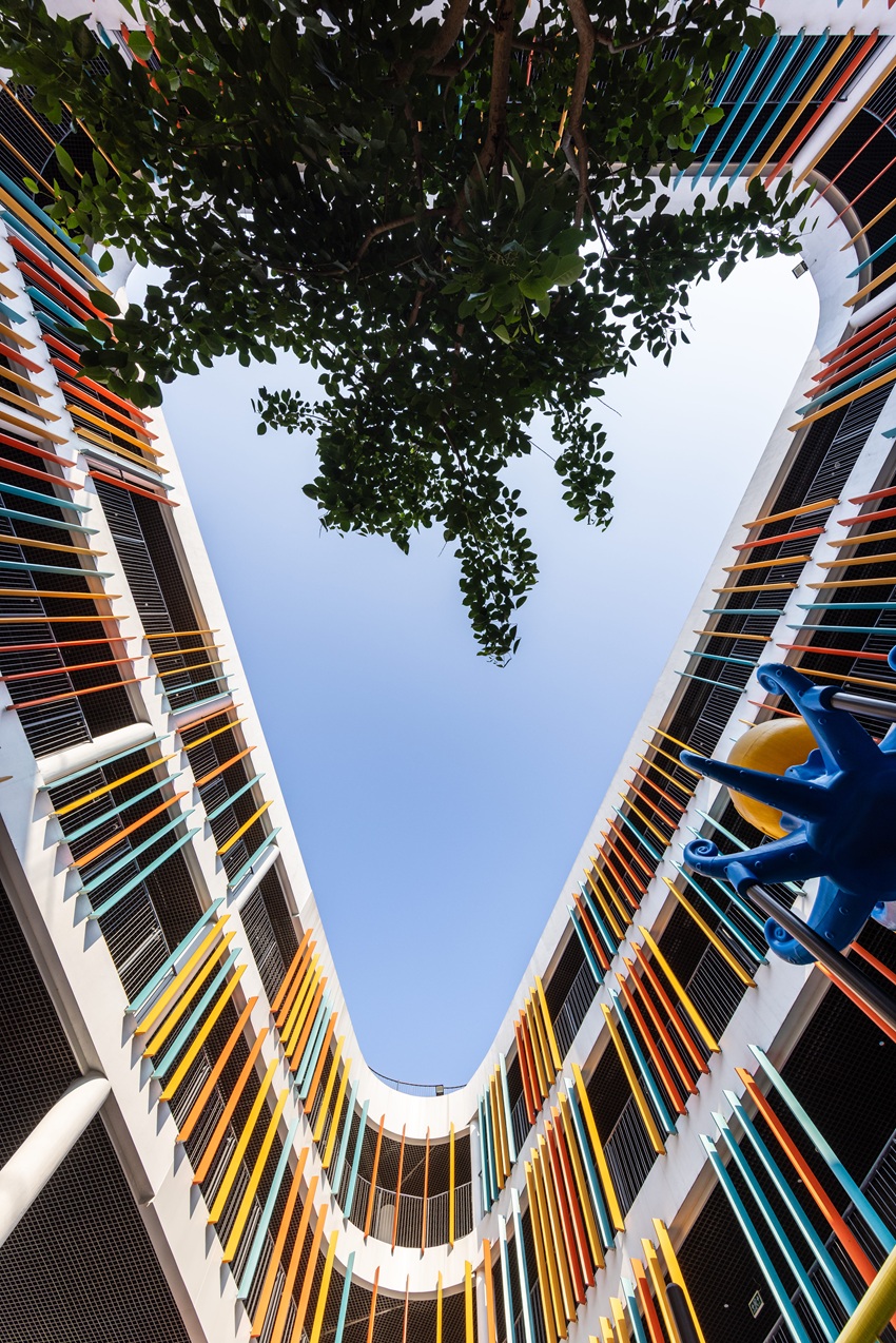 elliptical classroom volumes and colorful louvers shape courtyard kindergarten in hanoi - 4
