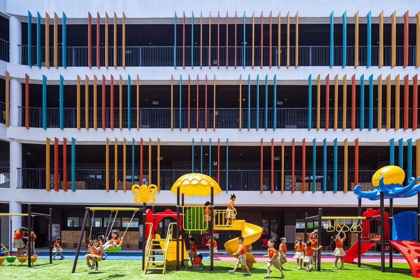 elliptical classroom volumes and colorful louvers shape courtyard kindergarten in hanoi - 3