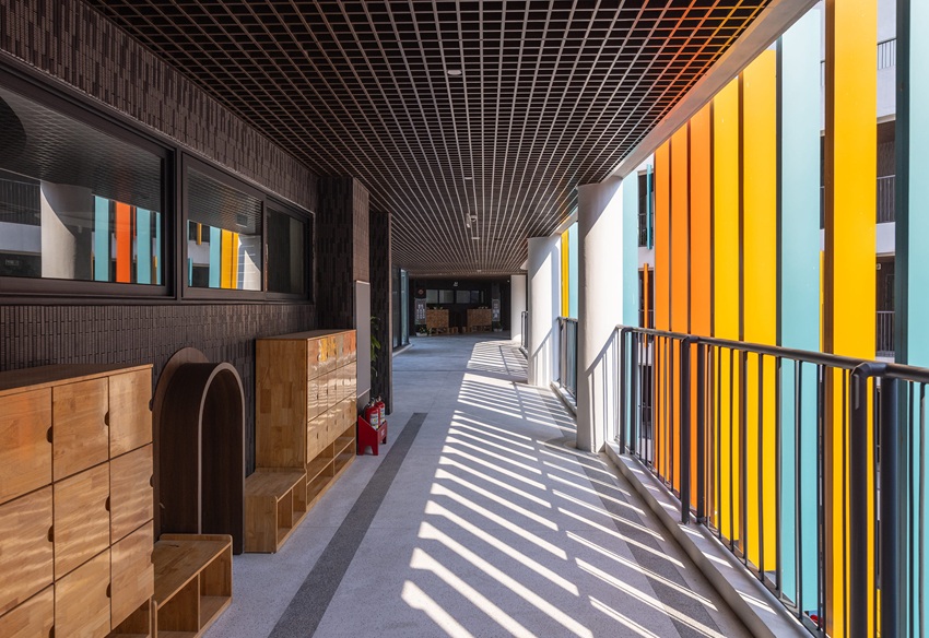 elliptical classroom volumes and colorful louvers shape courtyard kindergarten in hanoi - 5