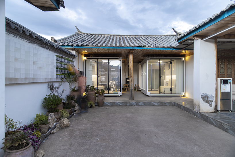 modular cabins made of aluminum and glass embed into village houses of rural china