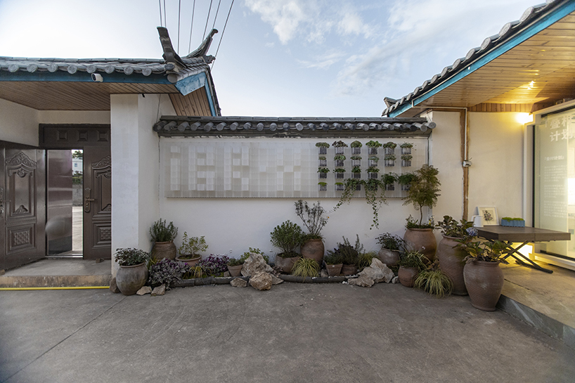 modular cabins made of aluminum and glass embed into village houses of rural china