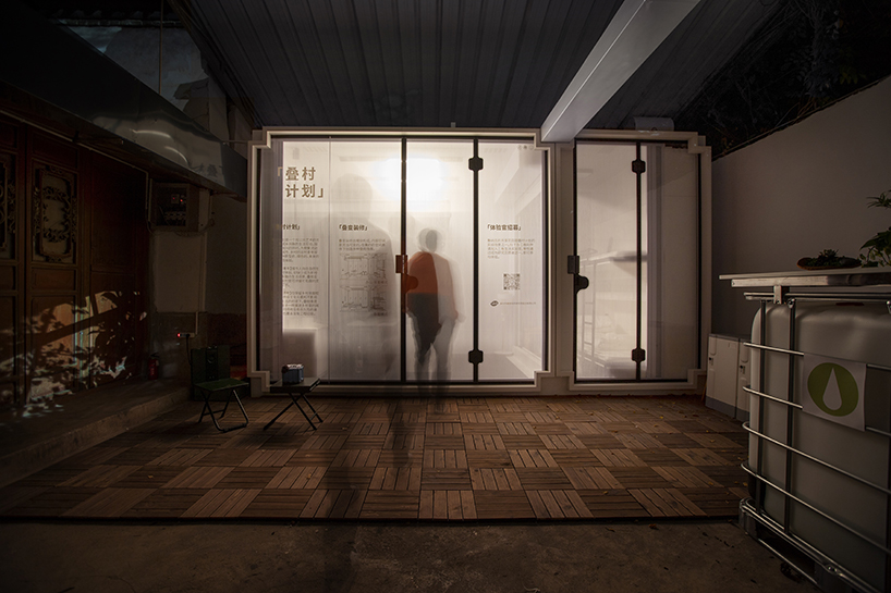 modular cabins made of aluminum and glass embed into village houses of rural china