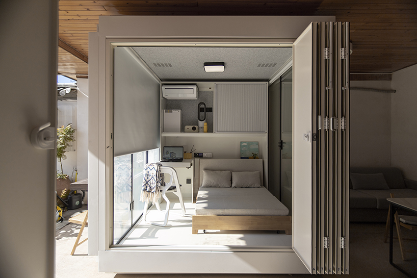 modular cabins made of aluminum and glass embed into village houses of rural china