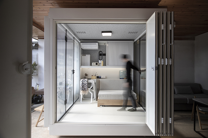 modular cabins made of aluminum and glass embed into village houses of rural china