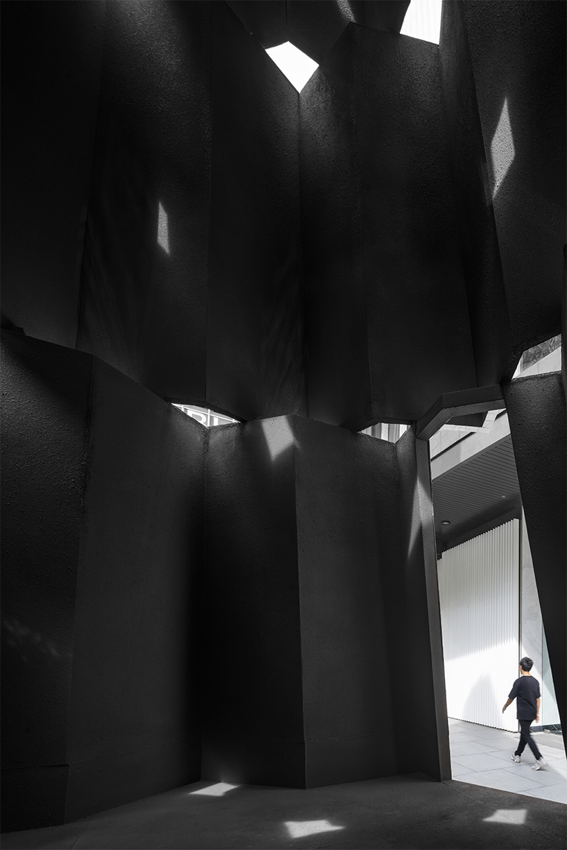 sanitas studio's installations juxtapose contemplative mirrors and earth in bangkok