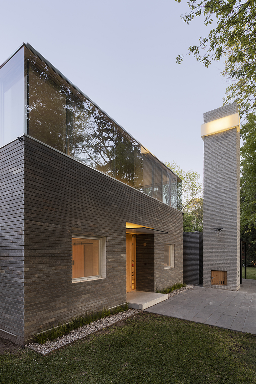 cabin 192's brick volume upholds glazed box in suburban area of buenos aires