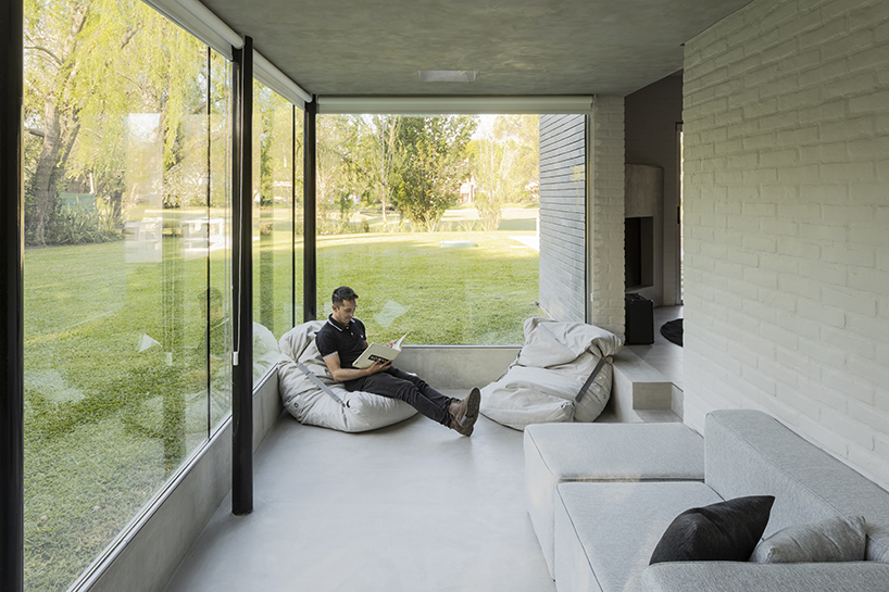 cabin 192's brick volume upholds glazed box in suburban area of buenos aires