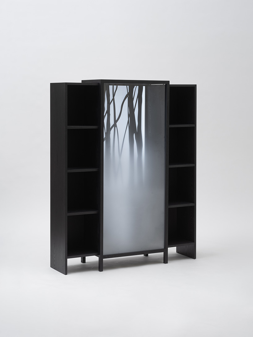 jisu kim's sliding ash wood bookshelf captures the icy chill of a winter forest