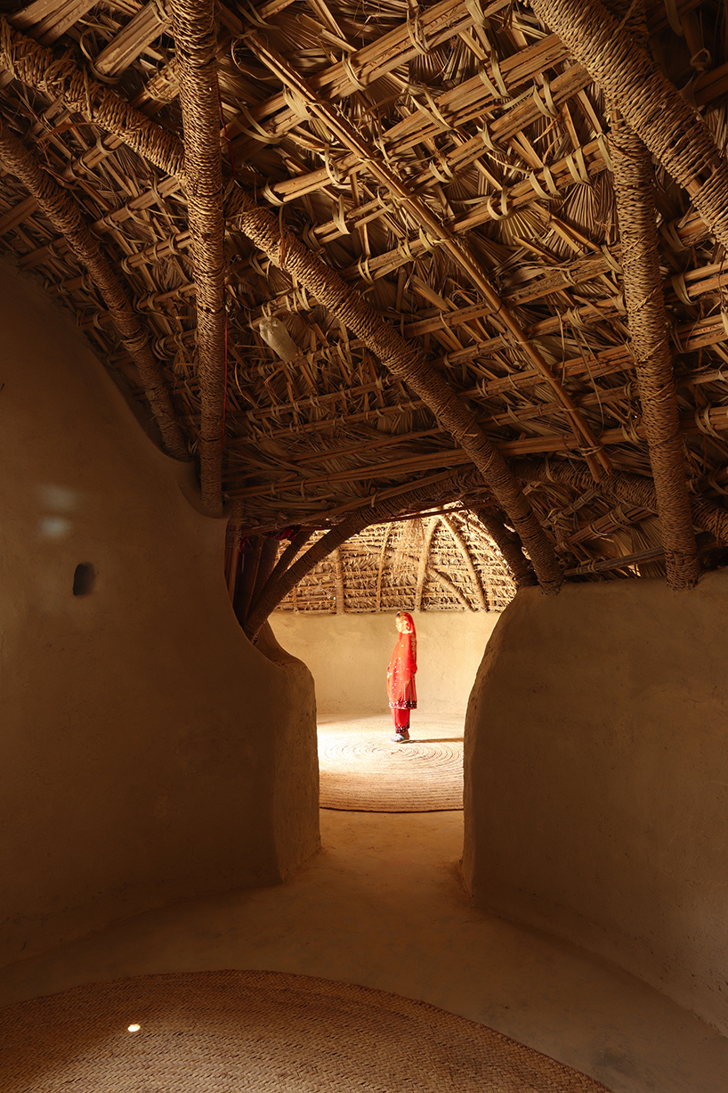 vaulted palm canopy shields dry stone guesthouse cluster in southeastern iran