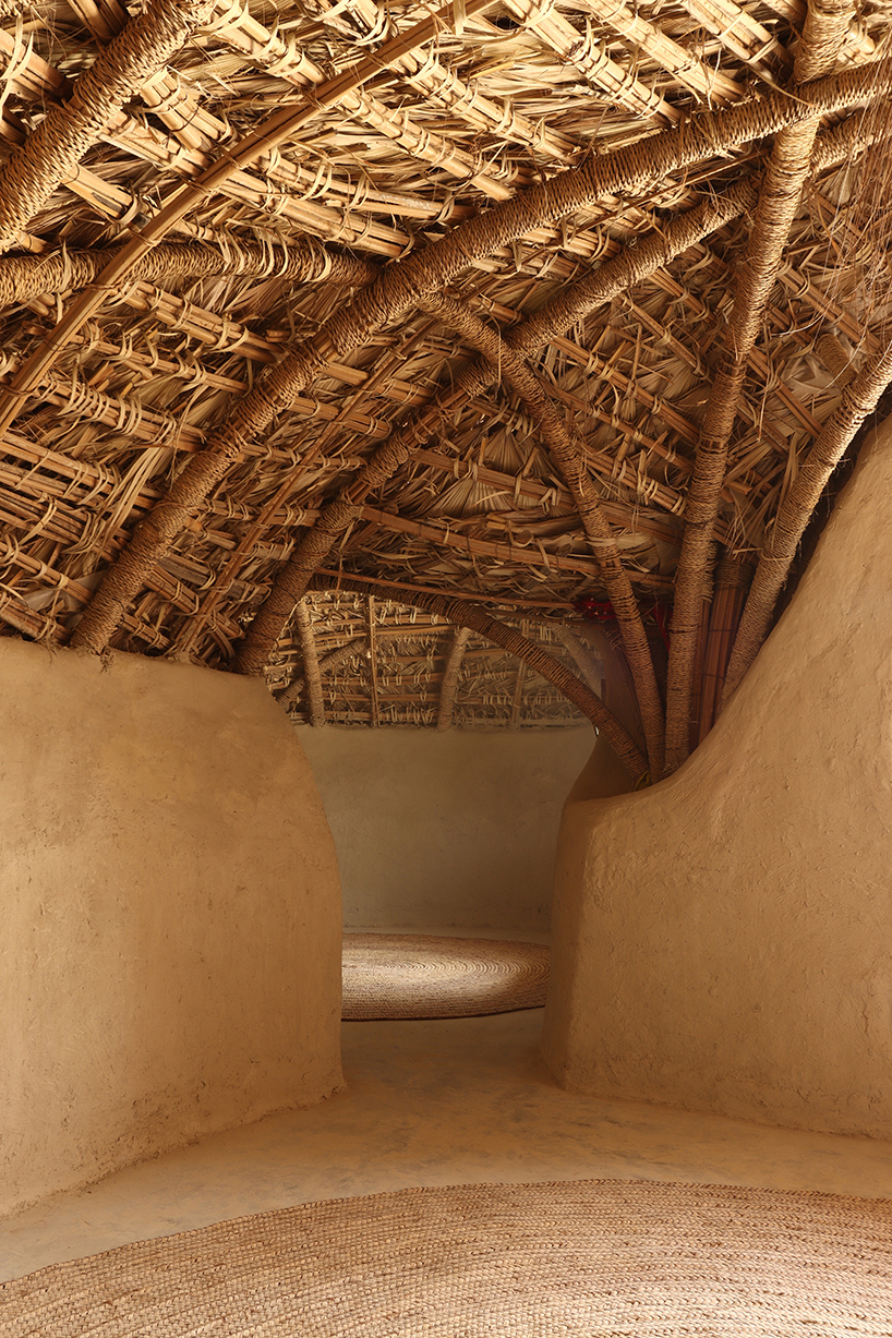vaulted palm canopy shields dry stone guesthouse cluster in southeastern iran
