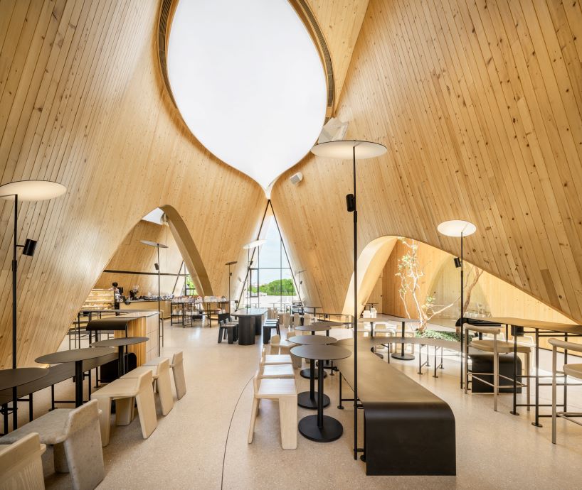 rounded openings pierce duo of sweeping gabled roofs at IDIN architects' bangkok café