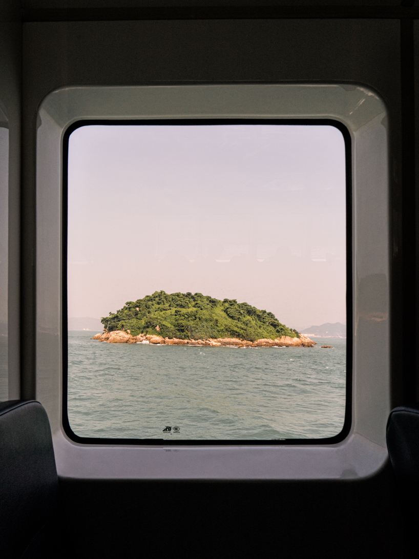 photographer captures cargo ships passing by on his ferry ride home