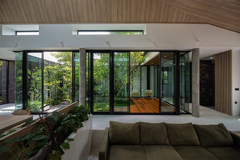 seven interconnected courtyards weave greenery into studio bewell's house in bangkok