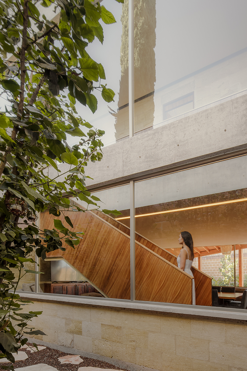 shielded portico encircles residence's square volumes in mexico