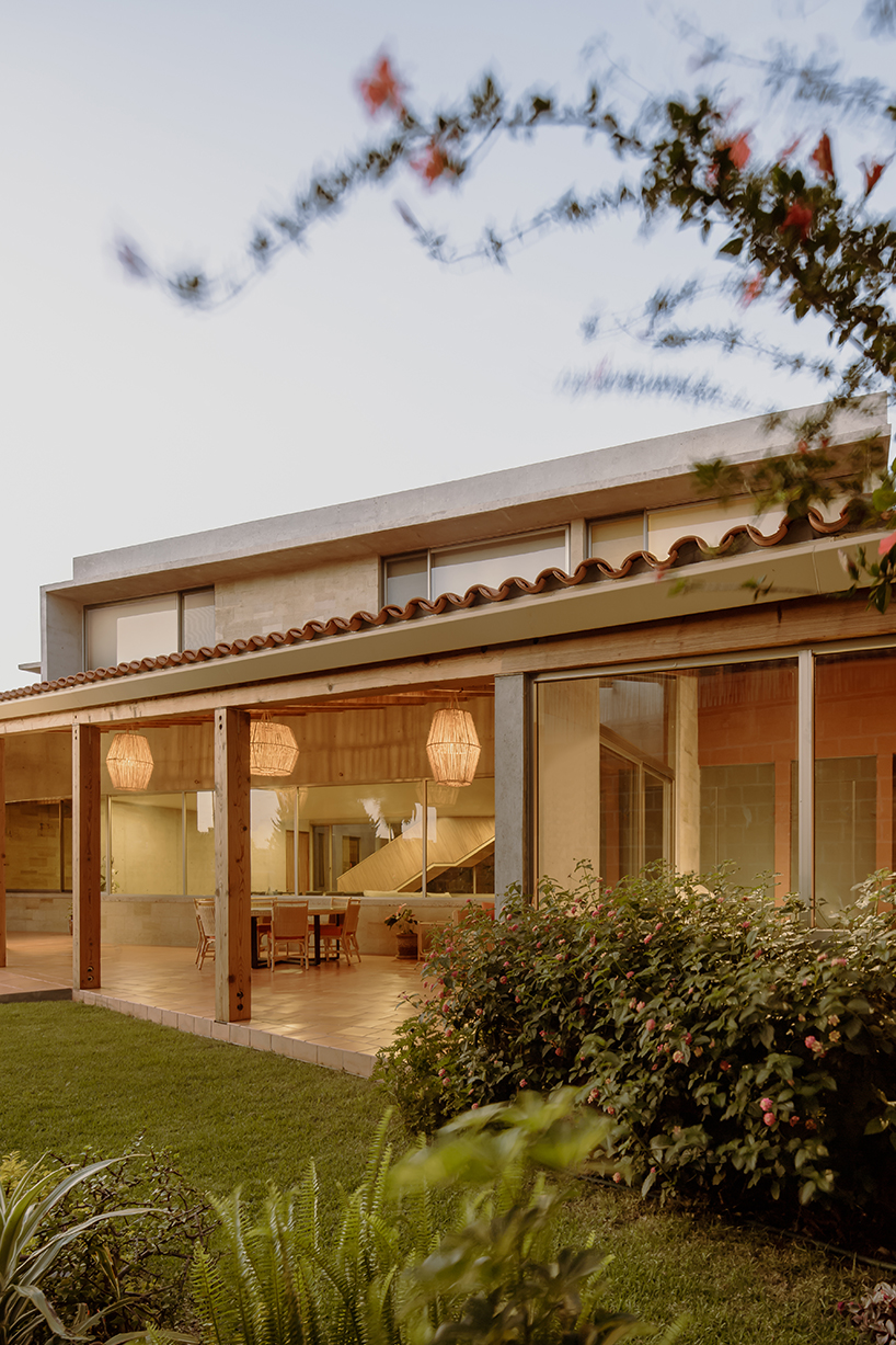 shielded portico encircles residence's square volumes in mexico