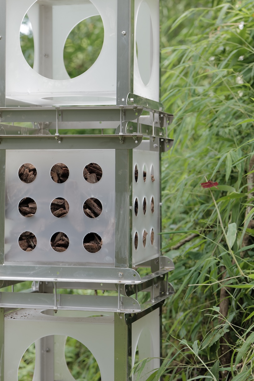 industrial modules and organic soil build architectural installation that grows with the forest
