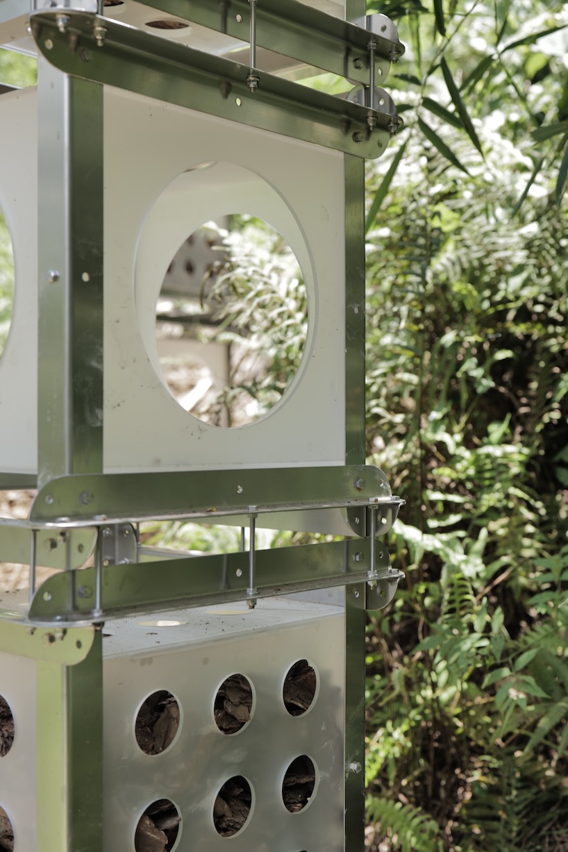 industrial modules and organic soil build architectural installation that grows with the forest