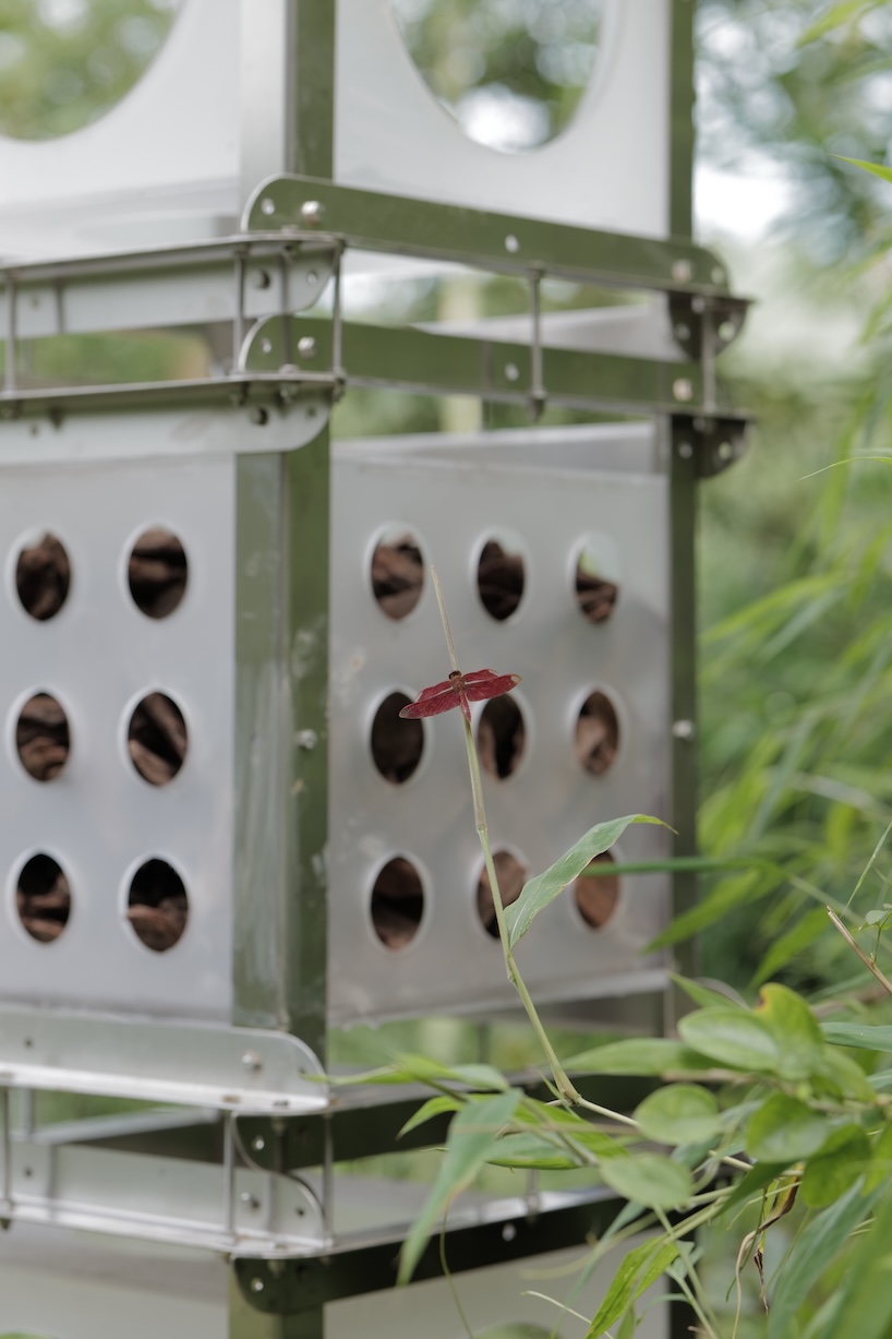 industrial modules and organic soil build architectural installation that grows with the forest