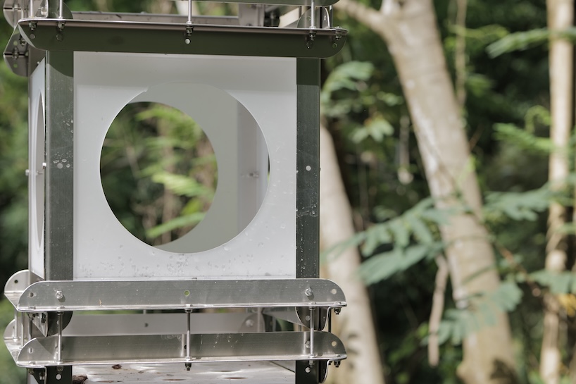 industrial modules and organic soil build architectural installation that grows with the forest