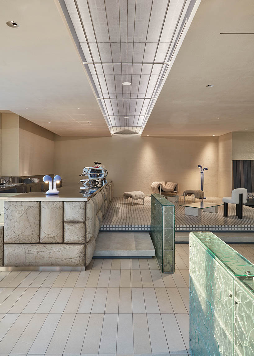 a box-like chandelier, concrete pillow bar, and icy walls enliven cafe by tee vee eff in dubai