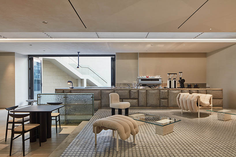 a box-like chandelier, concrete pillow bar, and icy walls enliven cafe by tee vee eff in dubai