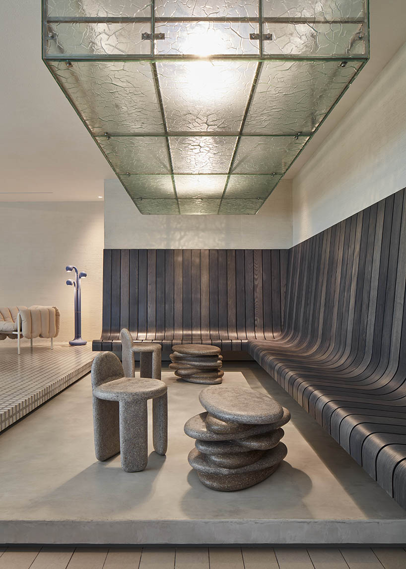 a box-like chandelier, concrete pillow bar, and icy walls enliven cafe by tee vee eff in dubai