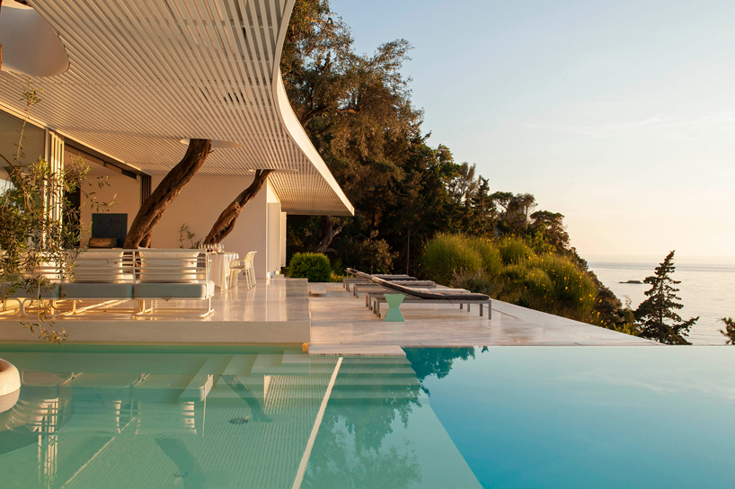 cantilever parabolic timber canopy tops holiday house h enclosed by corfu's rock formations